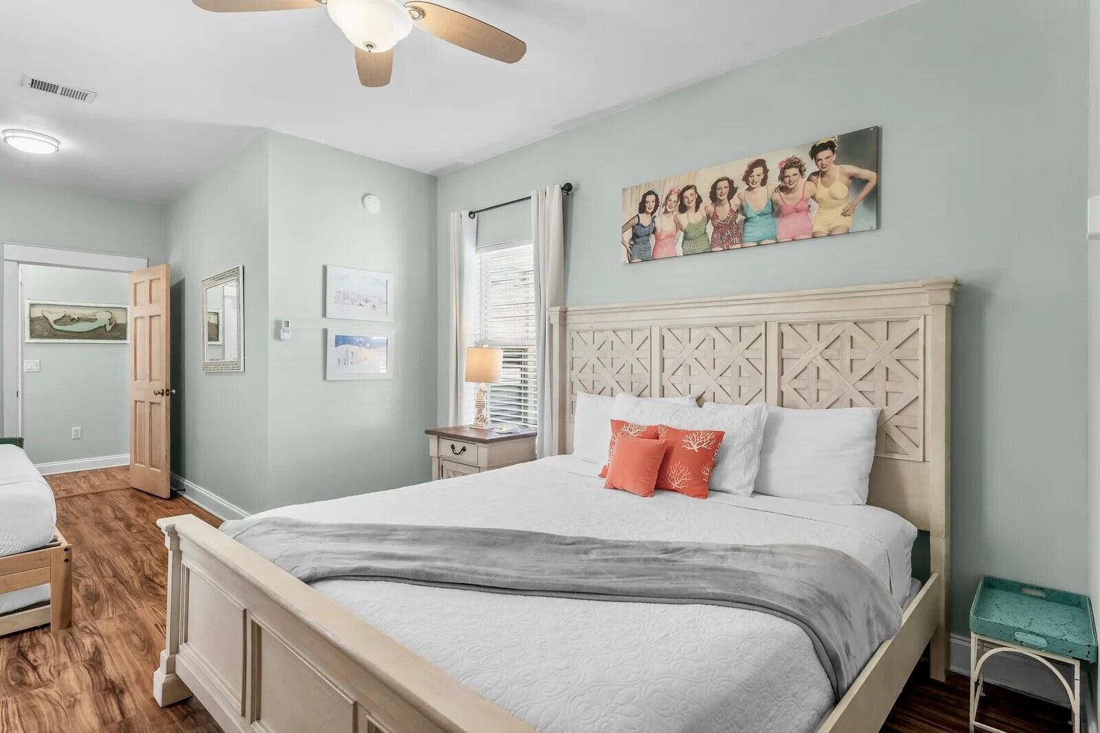 4503 John Avenue Destin, FL 32541 - Photo 24 of 51 a bedroom with a large bed and a chandelier