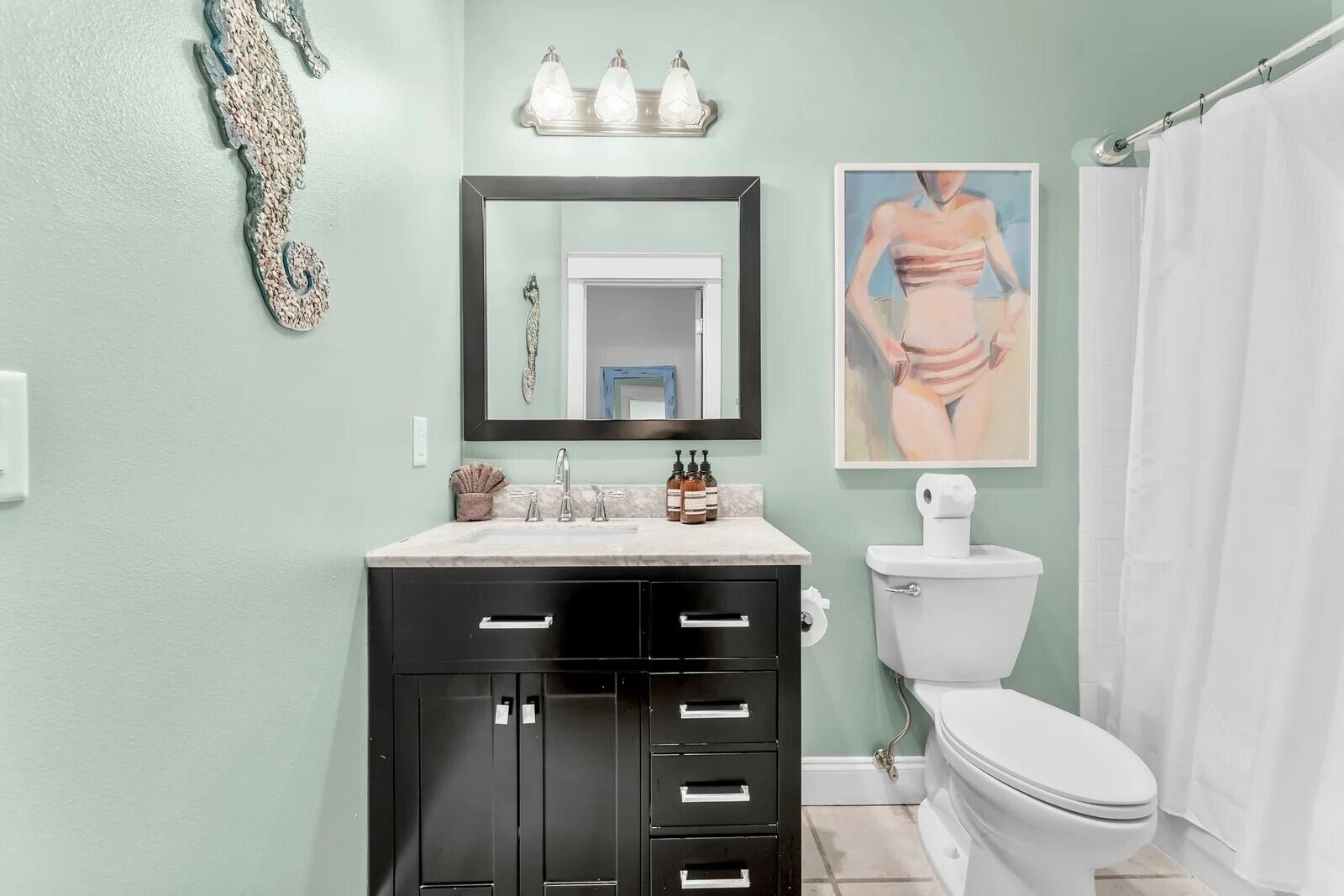 4503 John Avenue Destin, FL 32541 - Photo 25 of 51 a bathroom with a toilet sink and mirror