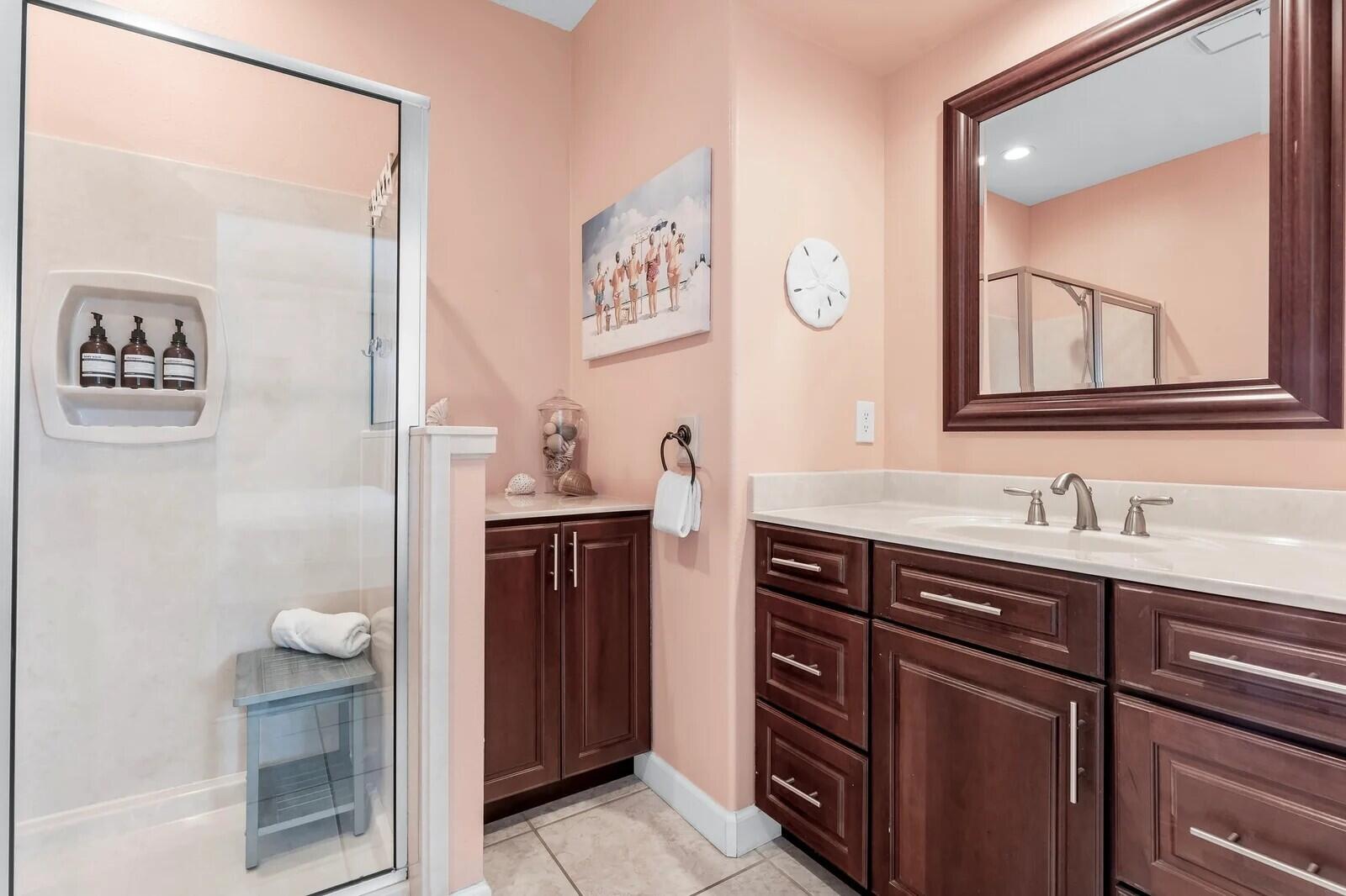 4503 John Avenue Destin, FL 32541 - Photo 29 of 51 a bathroom with a granite countertop sink a toilet a vanity and mirror