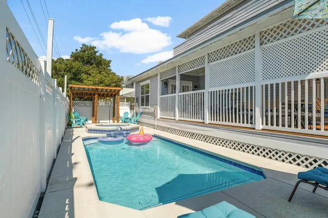 a view of a swimming pool with a yard