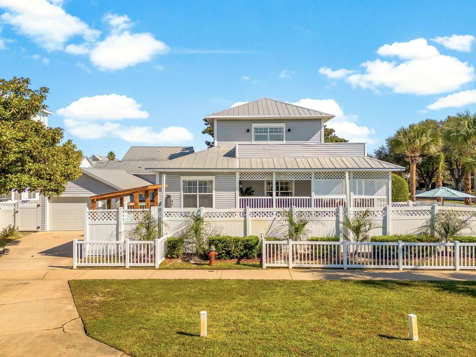4503 John Avenue Destin, FL 32541 - Photo 4 of 51 a front view of a house with swimming pool