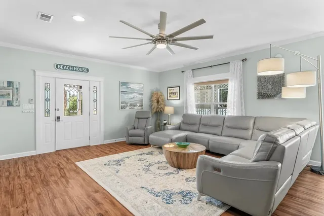 a living room with furniture and a wooden floor