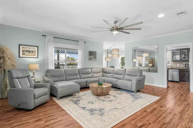 a living room with furniture and a wooden floor