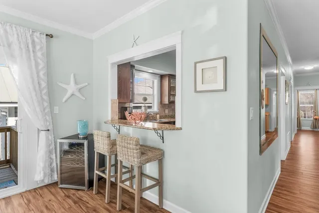 a dining room with furniture and wooden floor