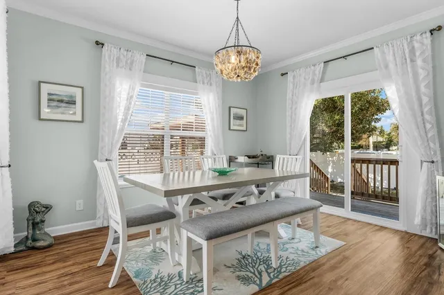 a view of a dining room with furniture wooden floor and a chandelier
