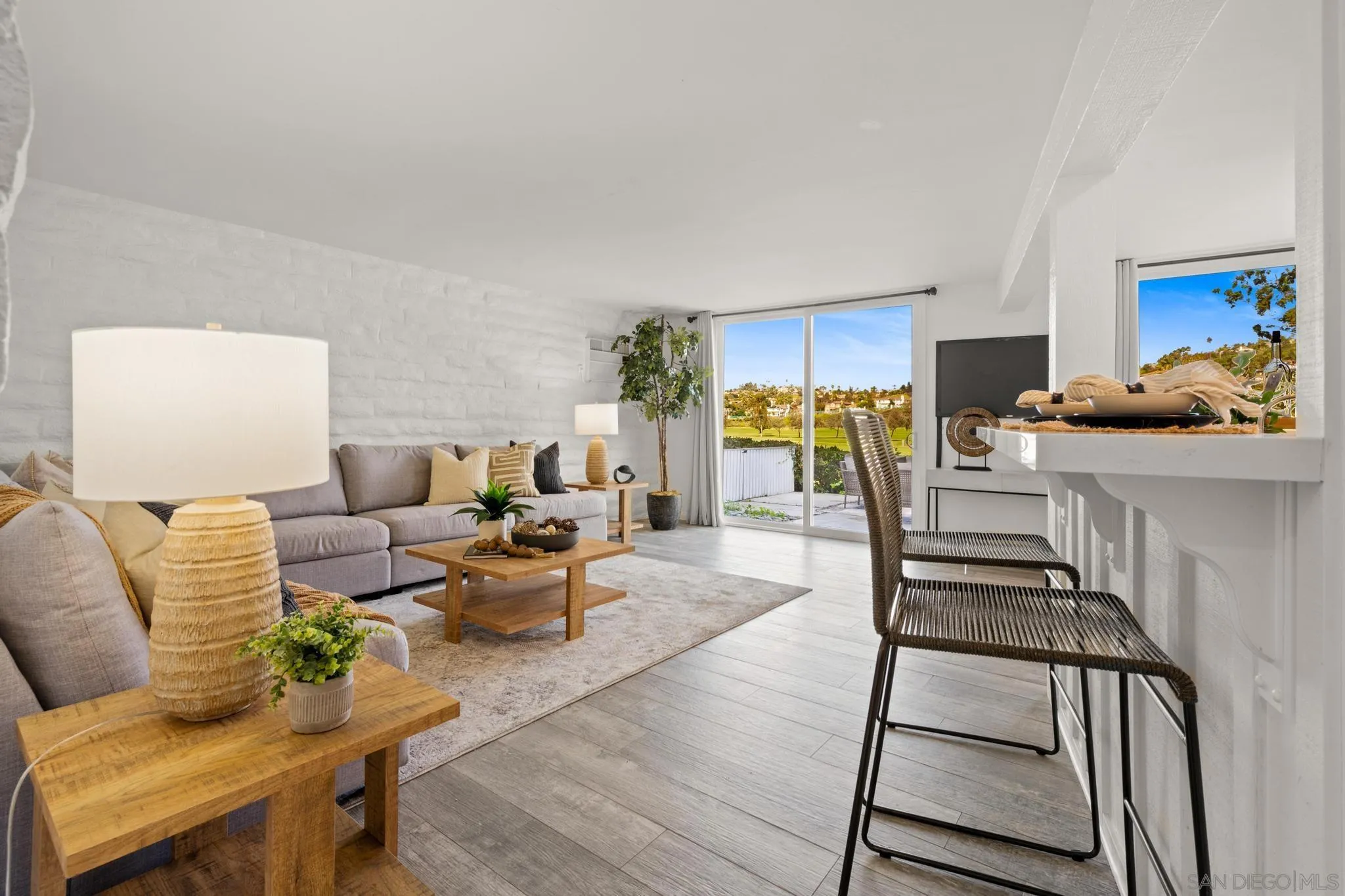 2544 Navarra Drive, Unit 17 Carlsbad, CA 92009 - Photo 13 of 24 a living room with furniture and a wooden floor