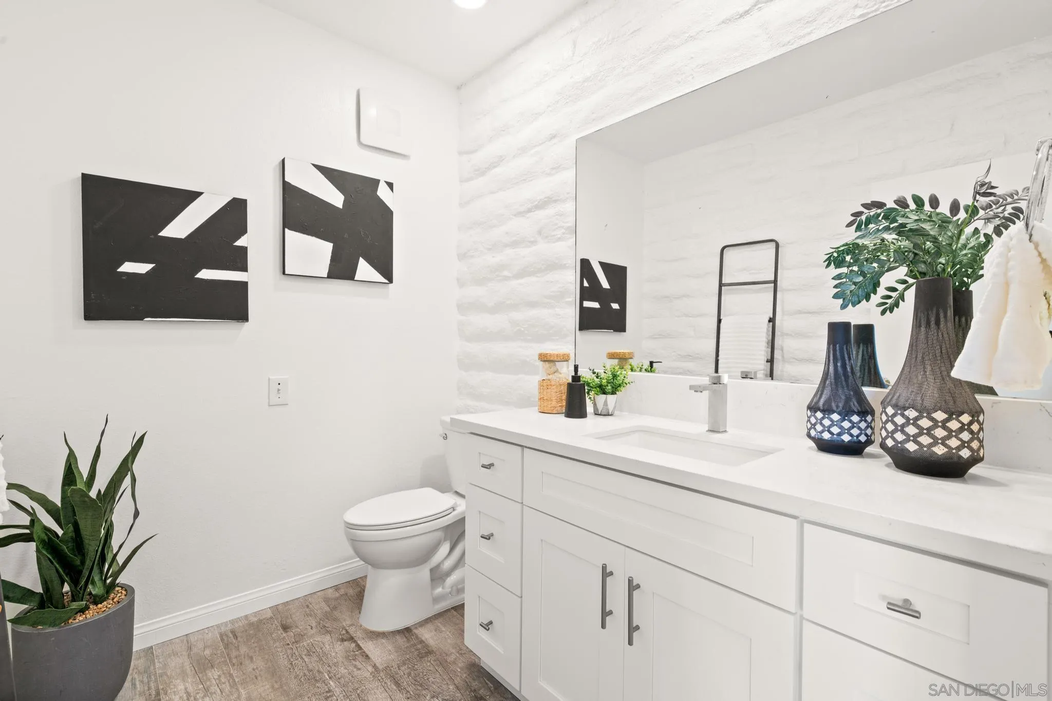 2544 Navarra Drive, Unit 17 Carlsbad, CA 92009 - Photo 19 of 24 a bathroom with a potted plant and a toilet