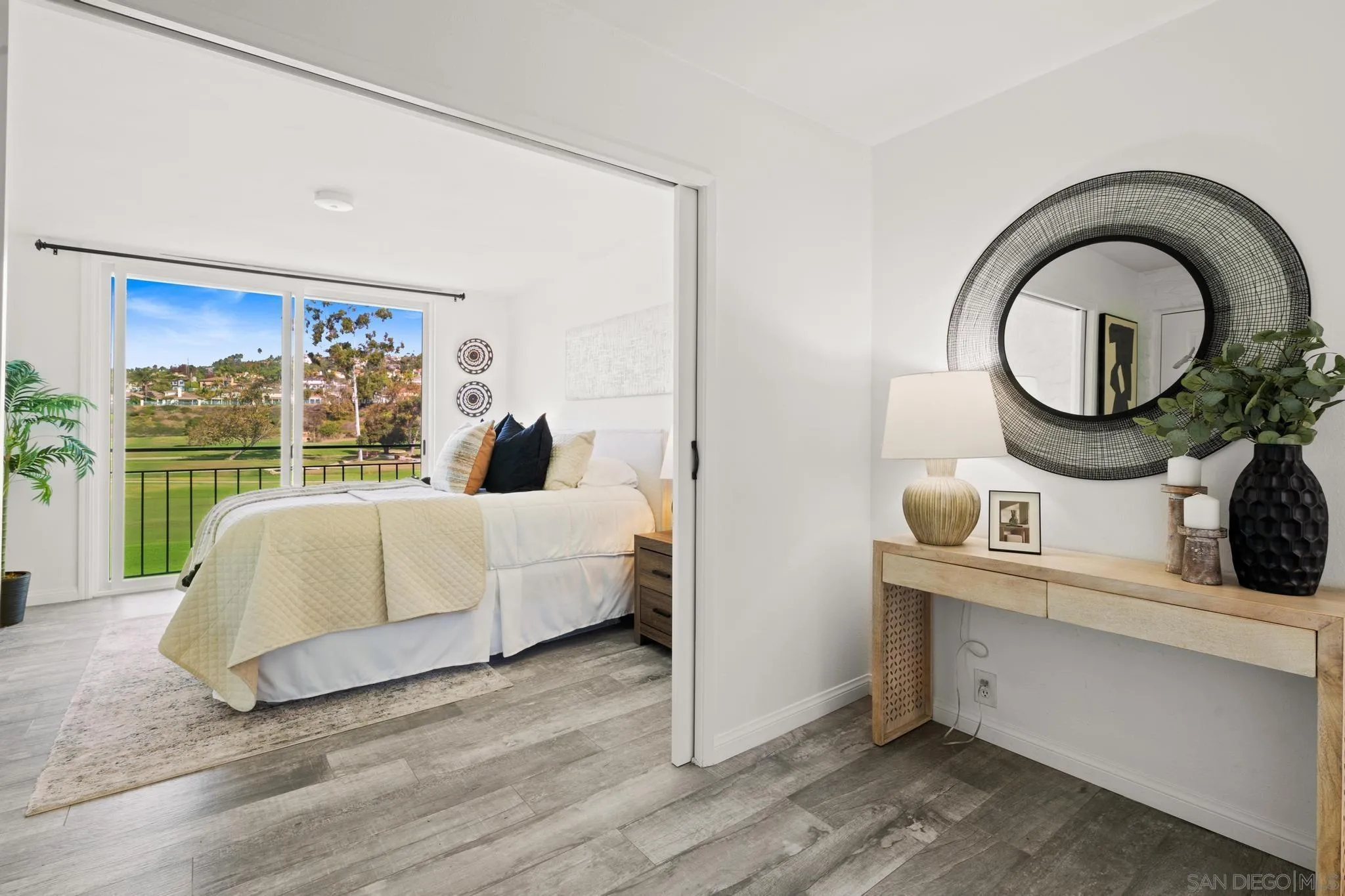 2544 Navarra Drive, Unit 17 Carlsbad, CA 92009 - Photo 2 of 24 a living room with a bed furniture and a large window