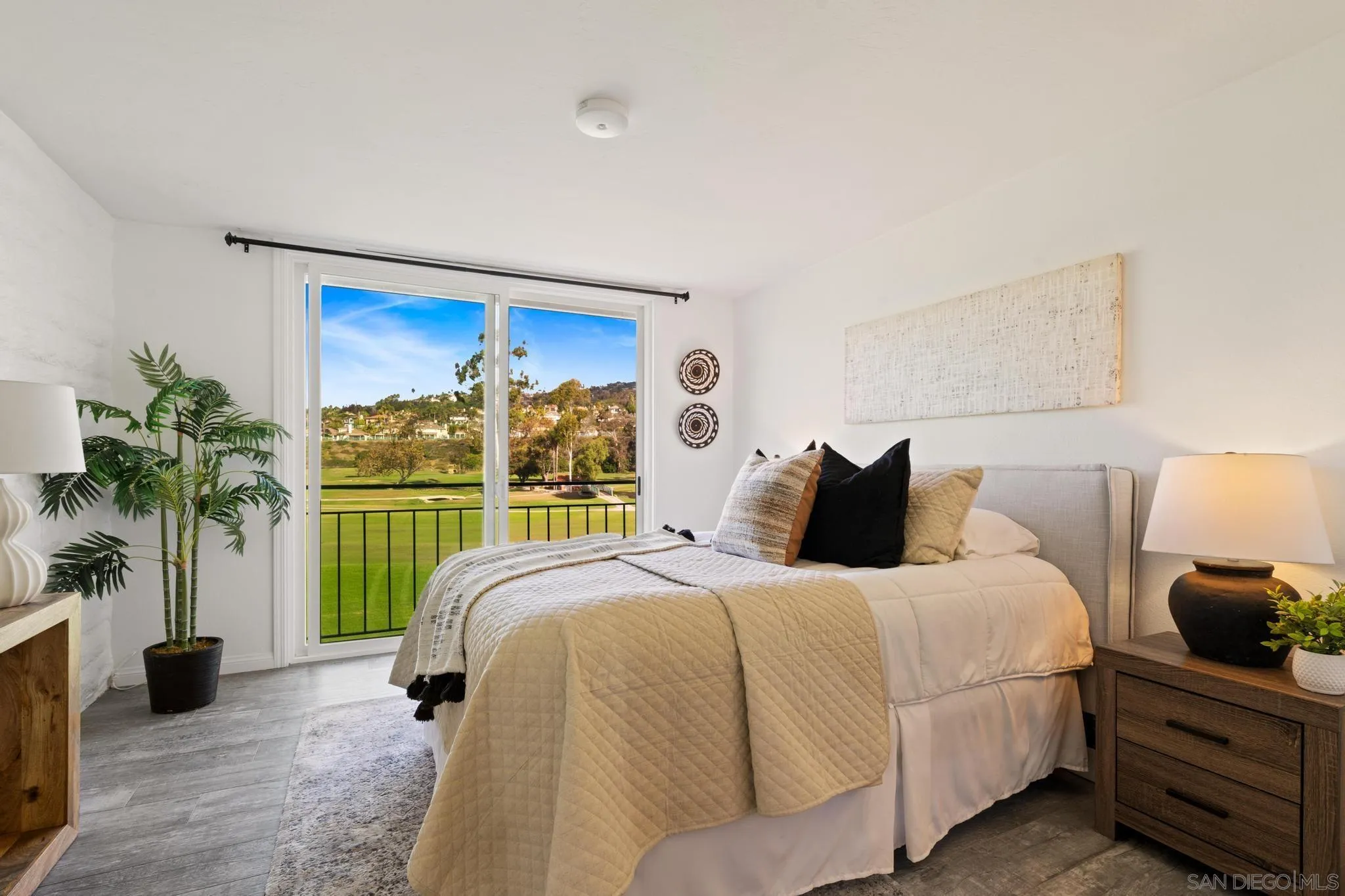 2544 Navarra Drive, Unit 17 Carlsbad, CA 92009 - Photo 3 of 24 a bedroom with a bed and a large window