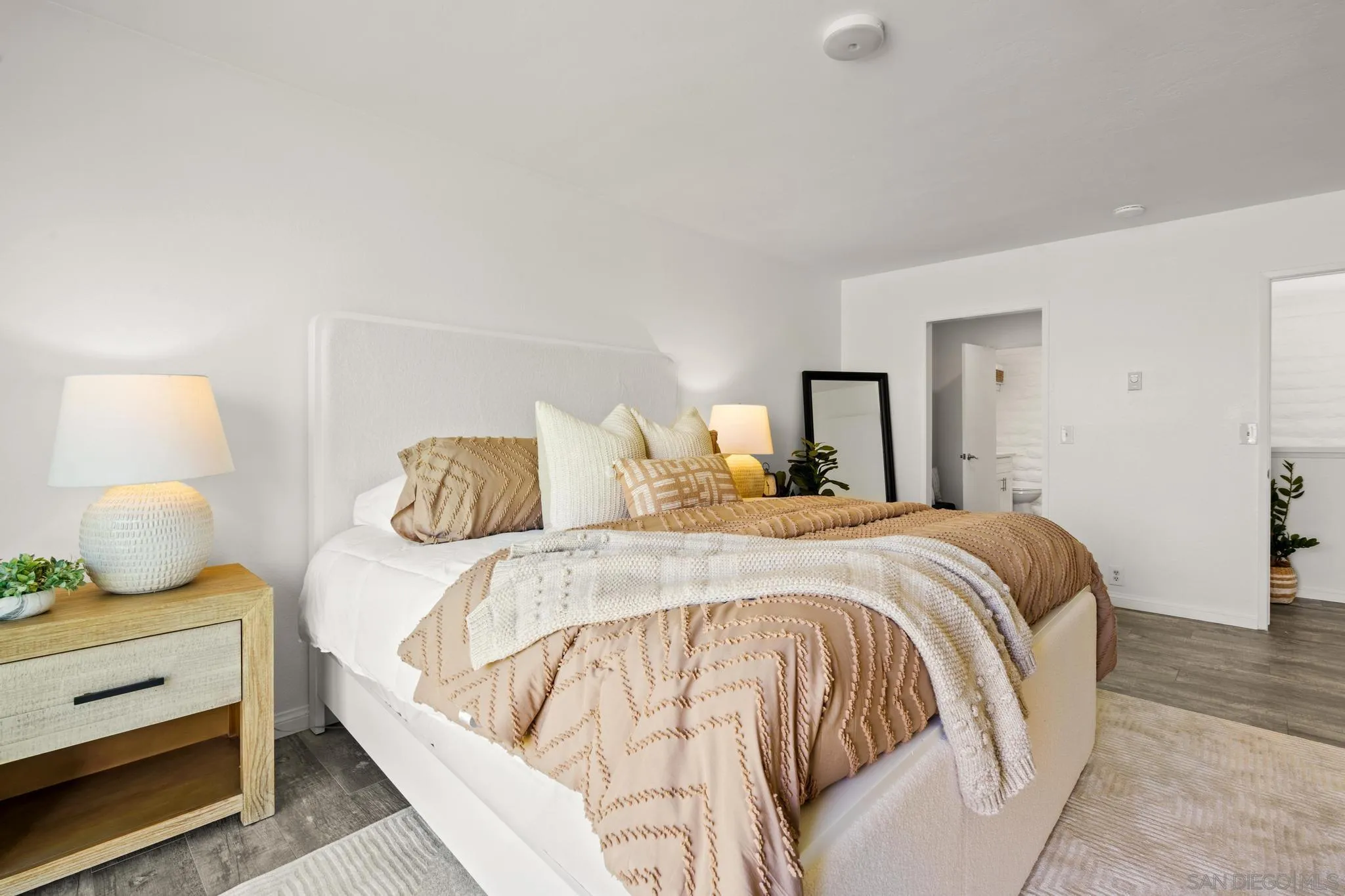 2544 Navarra Drive, Unit 17 Carlsbad, CA 92009 - Photo 8 of 24 a bedroom with a bed and lamp