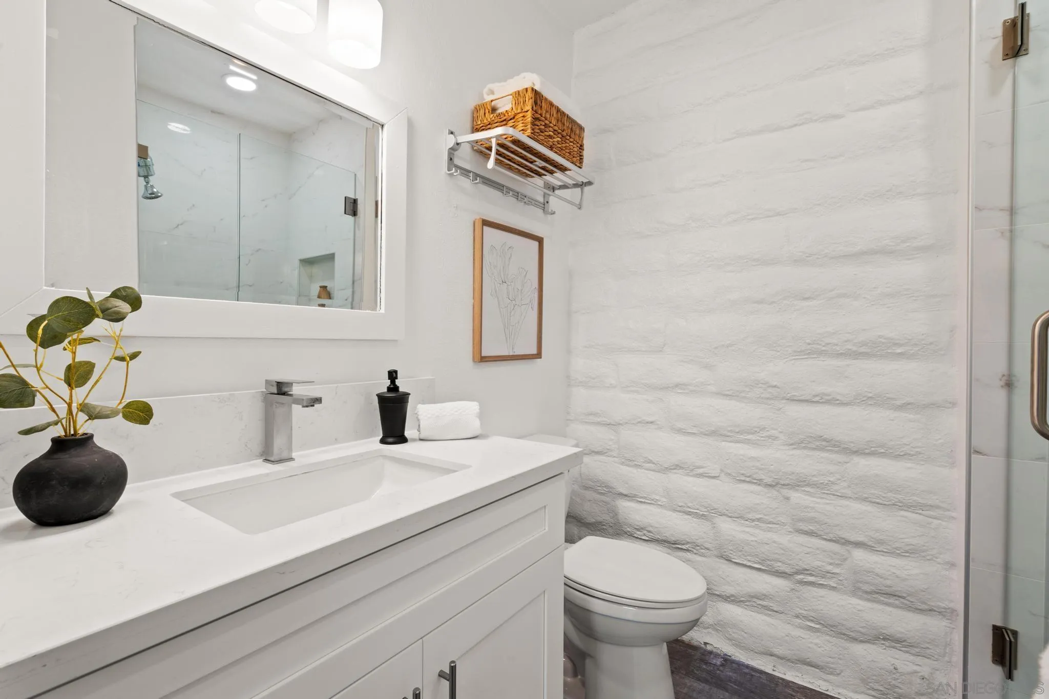 2544 Navarra Drive, Unit 17 Carlsbad, CA 92009 - Photo 9 of 24 a bathroom with a sink a toilet and mirror