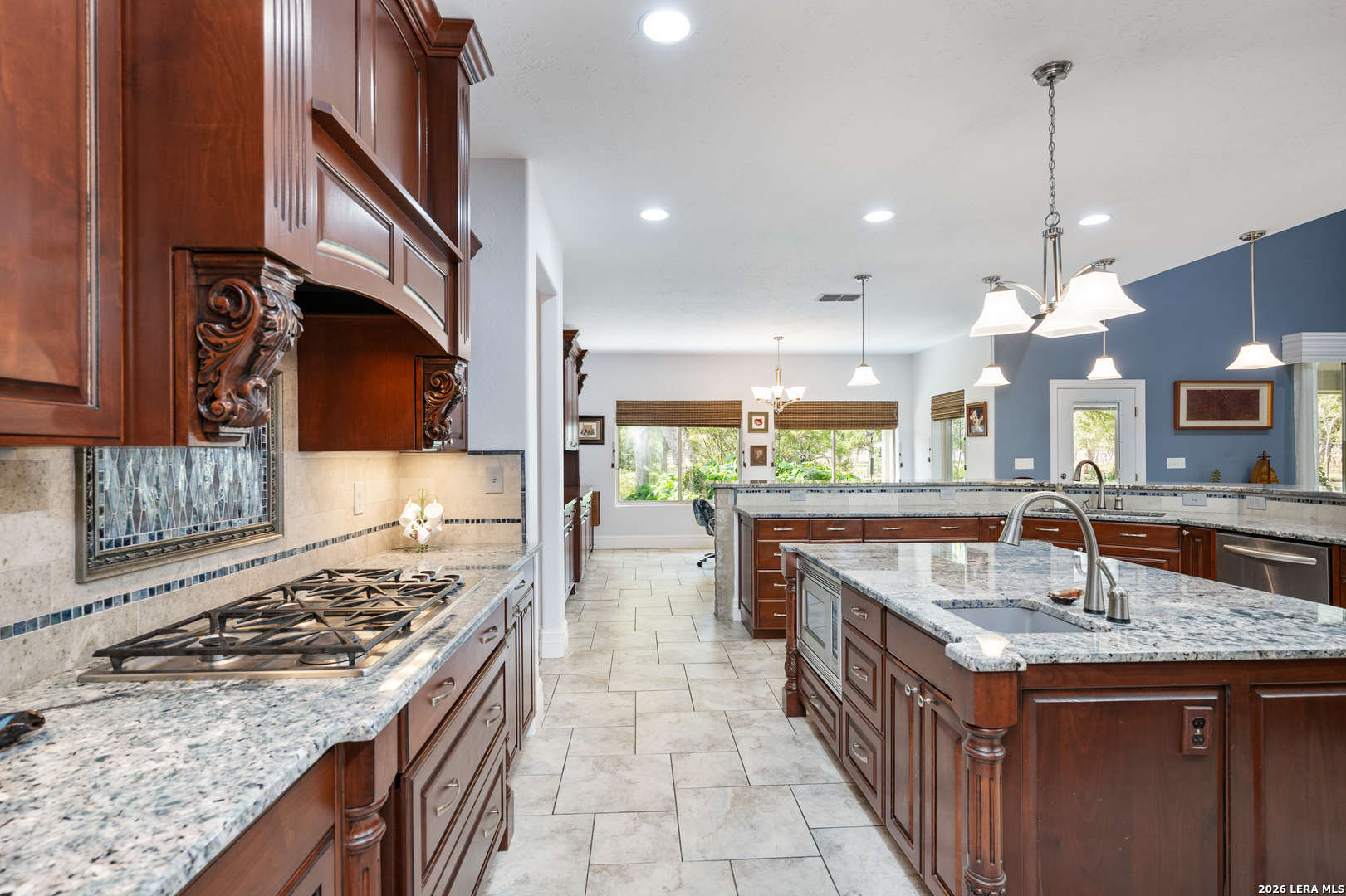 613 Saxet Trail Spring Branch, TX 78070 - Photo 12 of 50 a kitchen with kitchen island granite countertop a sink and a stove