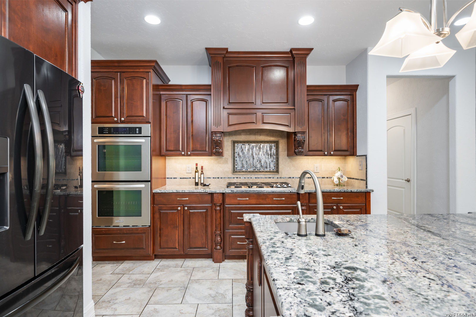 613 Saxet Trail Spring Branch, TX 78070 - Photo 14 of 50 a kitchen with stainless steel appliances granite countertop a refrigerator and a stove