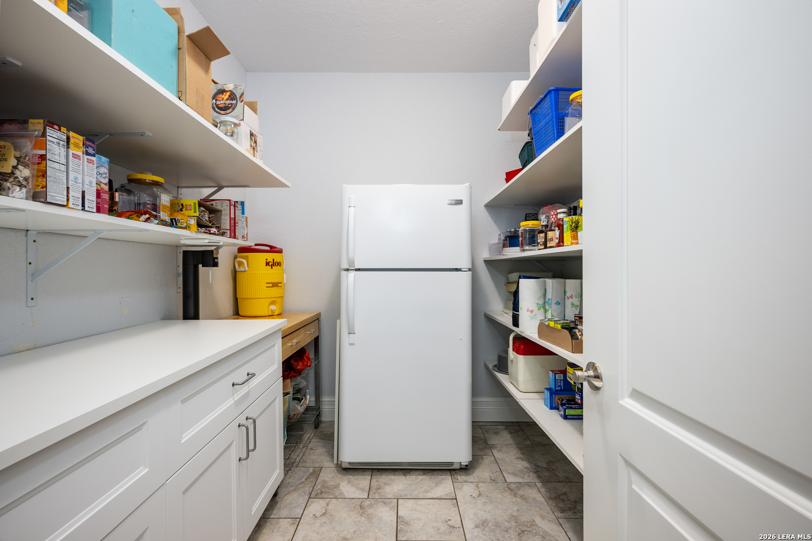 613 Saxet Trail Spring Branch, TX 78070 - Photo 17 of 50 a storage room with a refrigerator and cabinets