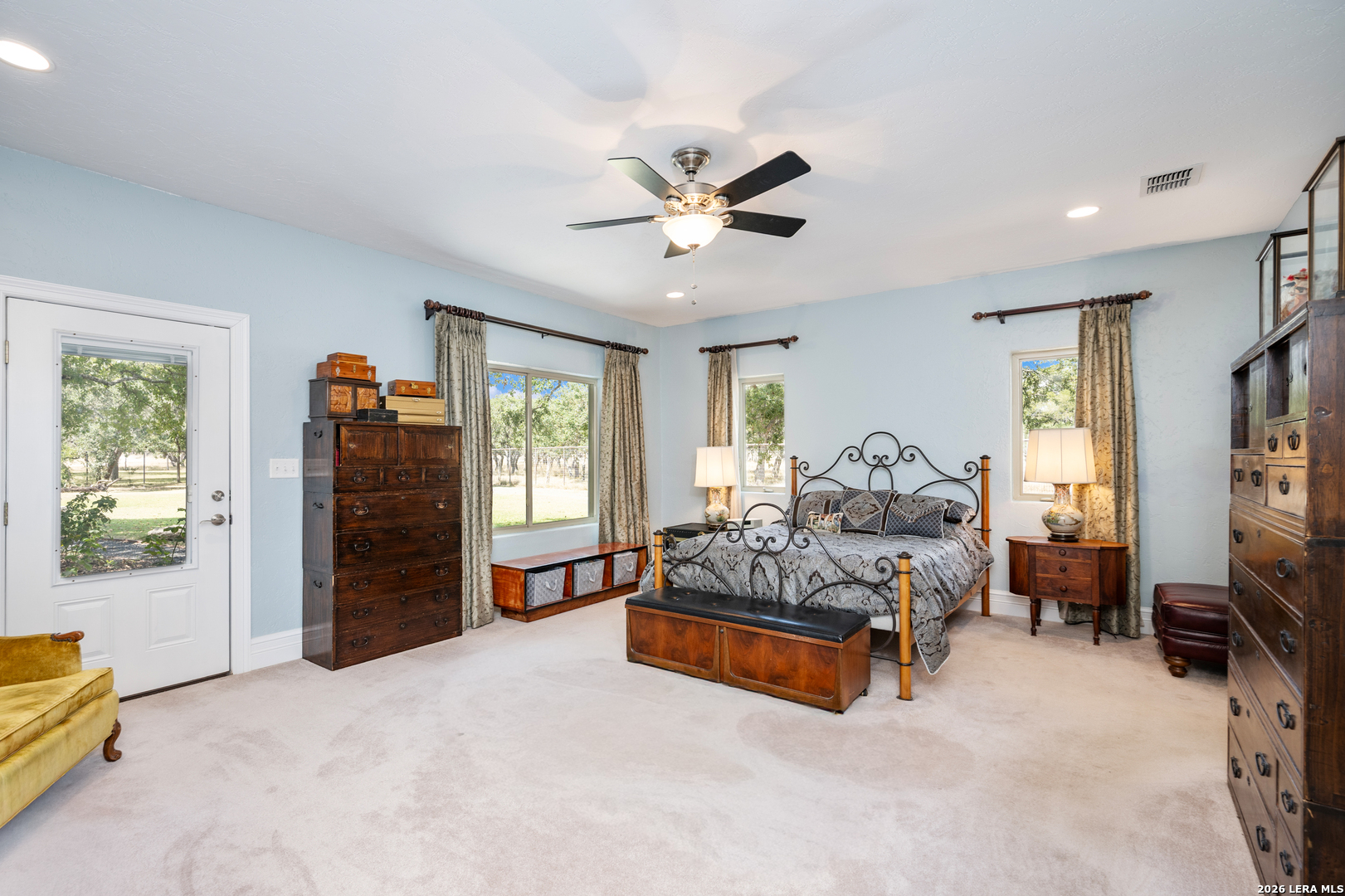 613 Saxet Trail Spring Branch, TX 78070 - Photo 21 of 50 a spacious bedroom with a bed and a chandelier
