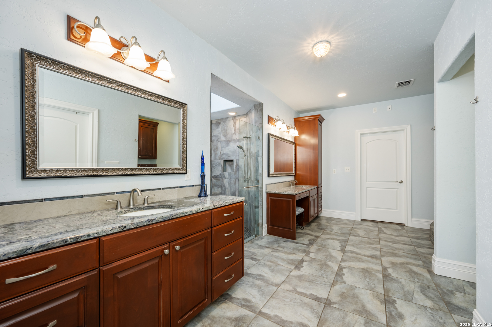 613 Saxet Trail Spring Branch, TX 78070 - Photo 22 of 50 a spacious bathroom with a double vanity sink a mirror and a shower
