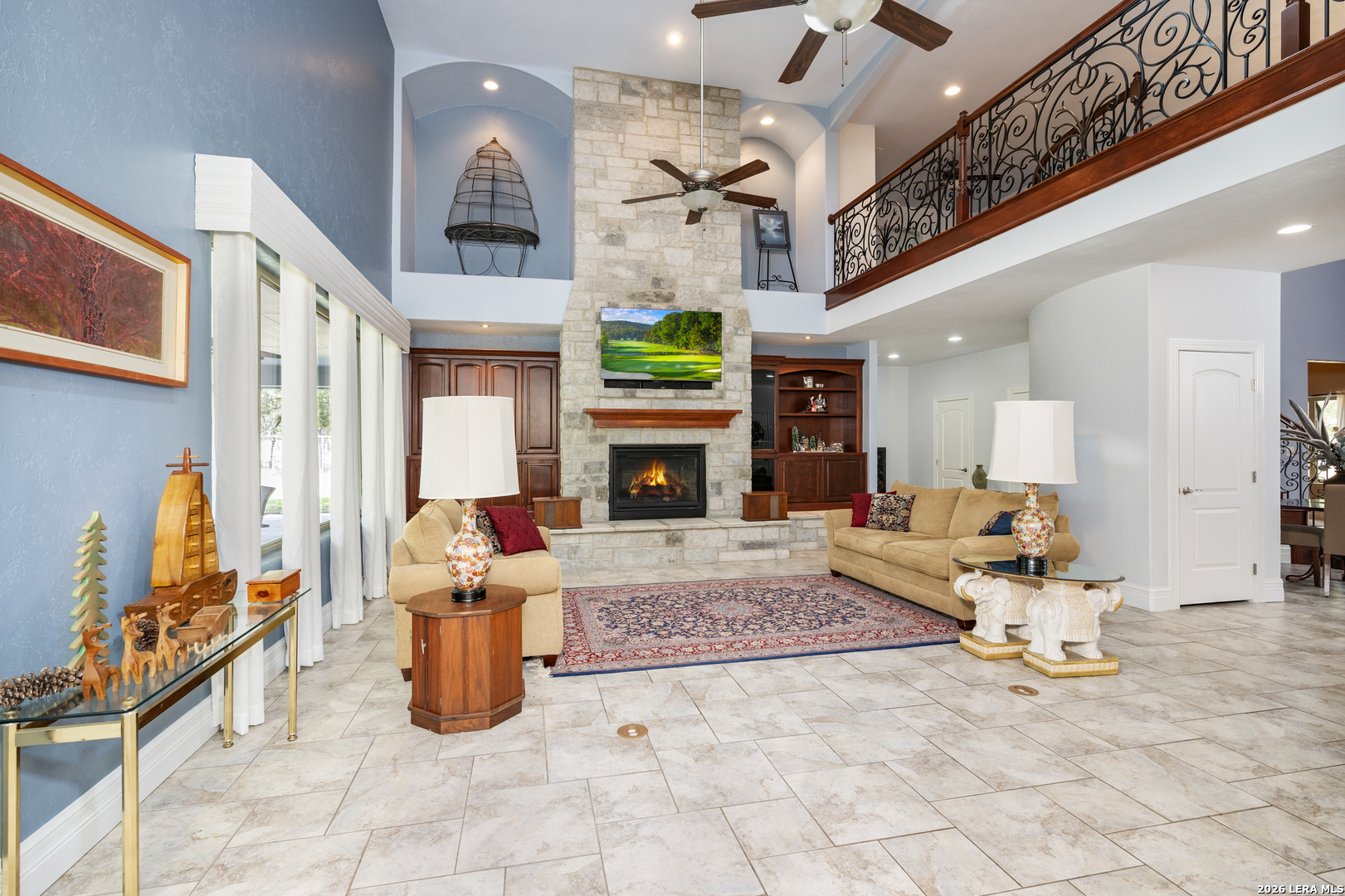 613 Saxet Trail Spring Branch, TX 78070 - Photo 7 of 50 a living room with furniture a fireplace and a chandelier