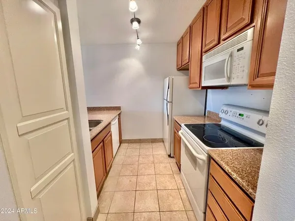 a kitchen with a sink a stove and cabinets