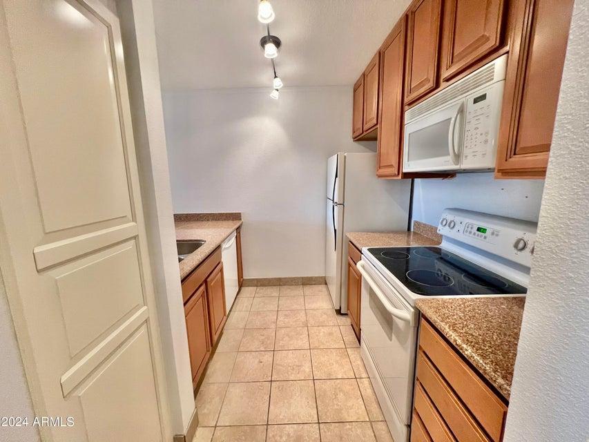 a kitchen with a sink a stove and cabinets