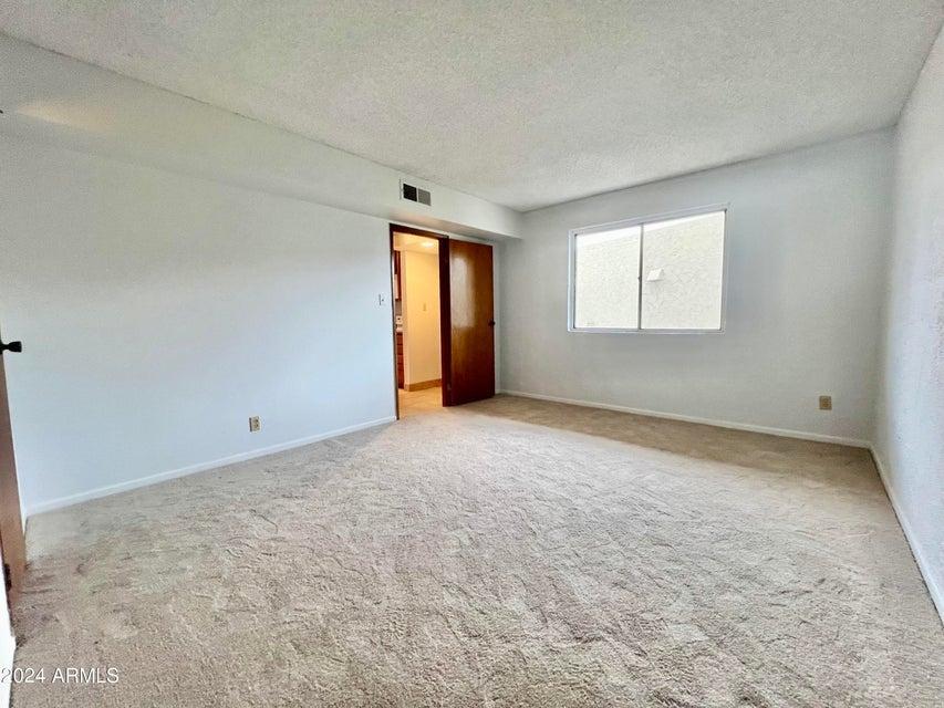 7625 East Camelback Road, Unit 415A Scottsdale, AZ 85251 - Photo 14 of 17 an empty room with windows and closet