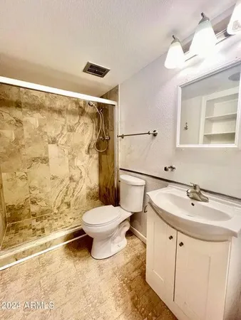 a bathroom with a sink toilet and shower