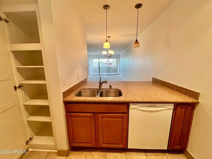 7625 East Camelback Road, Unit 415A Scottsdale, AZ 85251 - Photo 5 of 17 a kitchen with a sink a refrigerator and window
