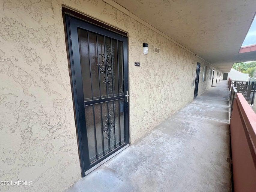 7625 East Camelback Road, Unit 415A Scottsdale, AZ 85251 - Photo 6 of 17 a view of a hallway with wooden floor and staircase