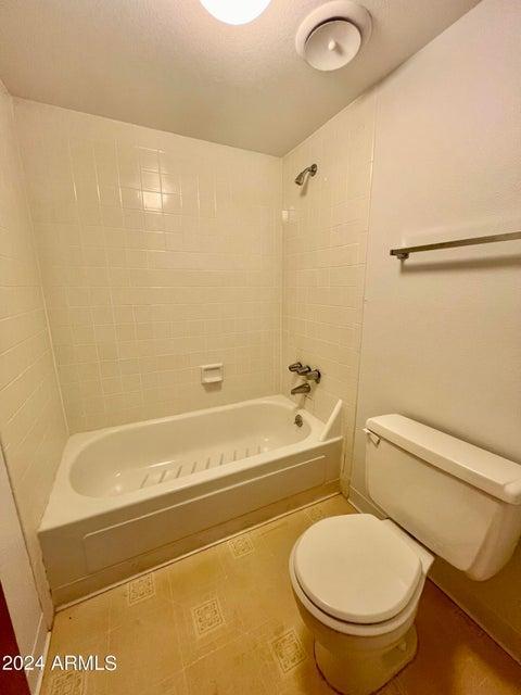 7625 East Camelback Road, Unit 415A Scottsdale, AZ 85251 - Photo 7 of 17 a bathroom with a toilet and a bath tub