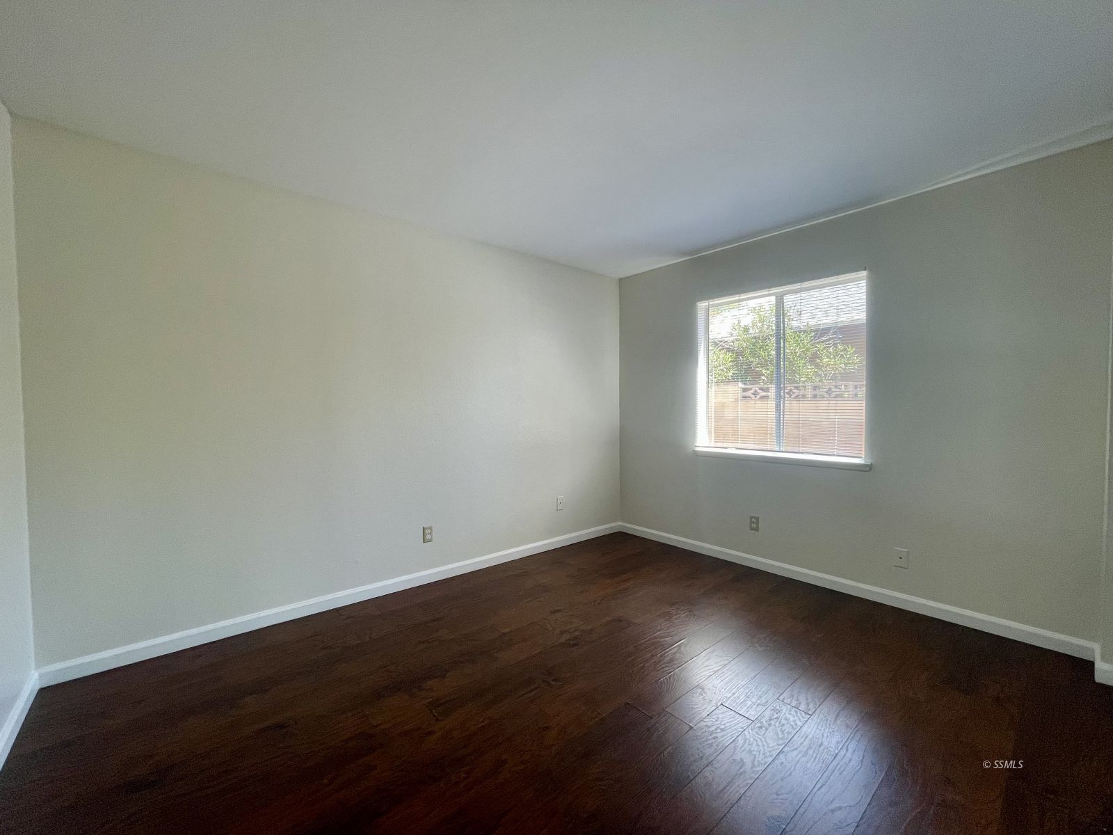225 East Rader Avenue Ridgecrest, CA 93555 - Photo 16 of 30 an empty room with wooden floor and windows