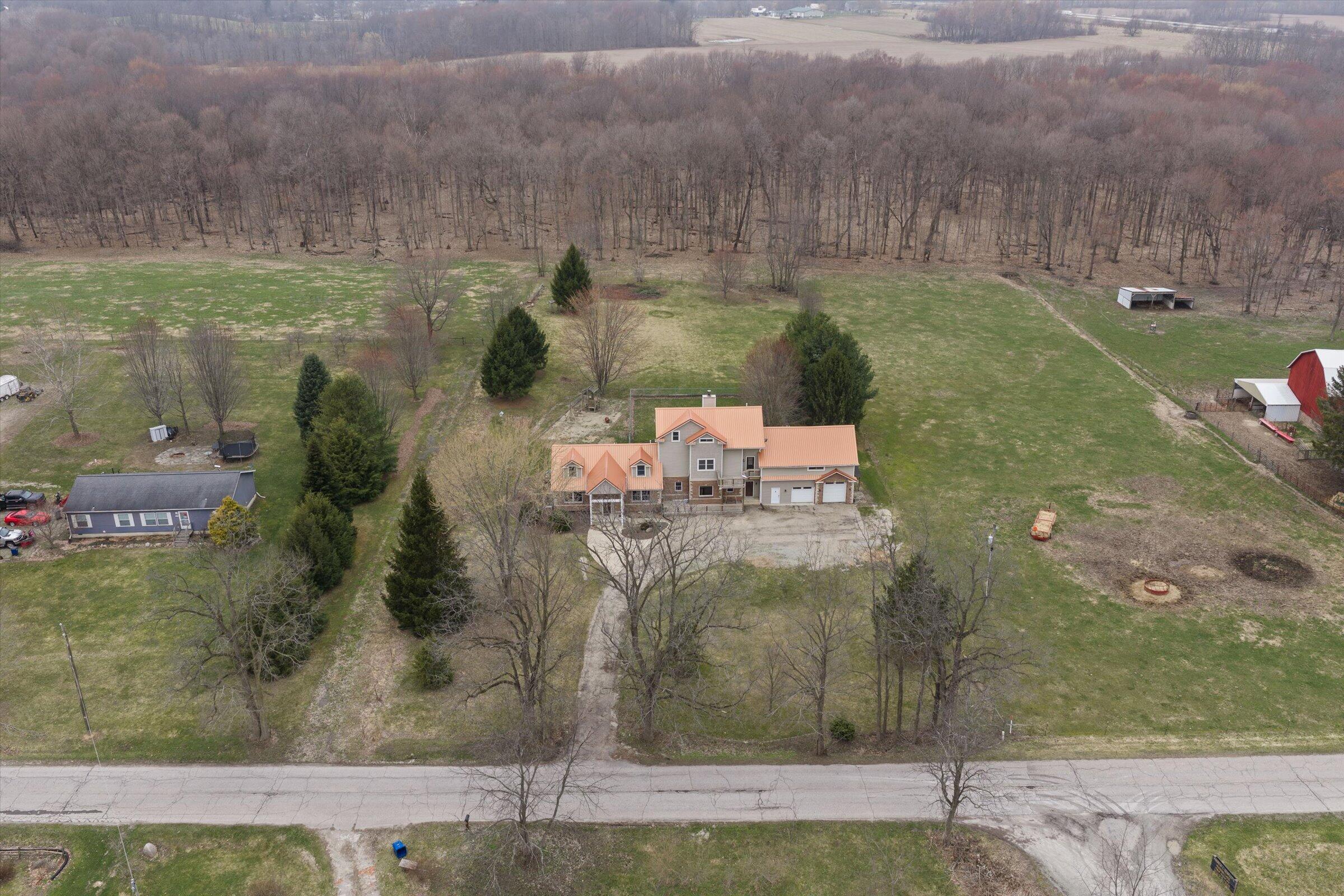 7692 North Emery Road Rolling Prairie, IN 46371 - Photo 62 of 69 an aerial view of a house with a yard