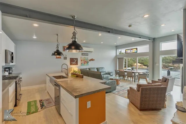a living room with furniture a large window and a flat screen tv