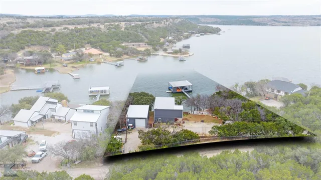 an aerial view of a house with balcony and trees al around