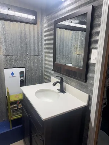 a bathroom with a toilet and a shower curtain