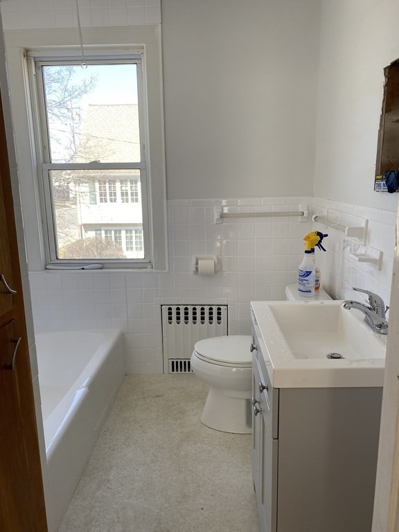 23 Main Street, Unit 2 Topsfield, MA 01983 - Photo 11 of 16 a bathroom with a sink a toilet and a window