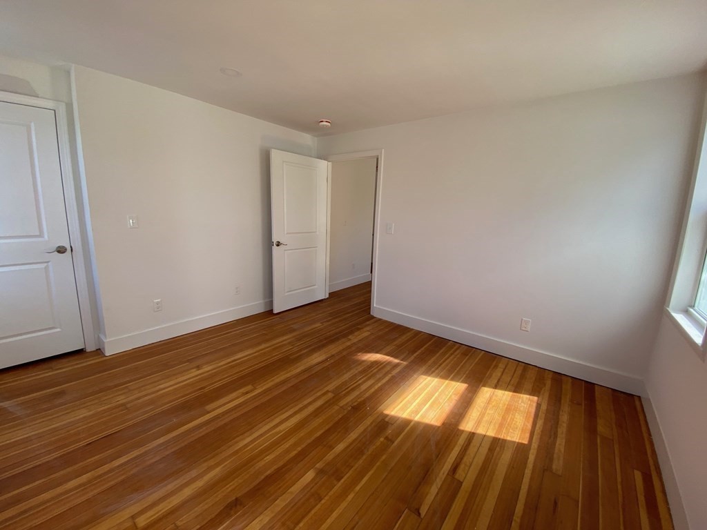 23 Main Street, Unit 2 Topsfield, MA 01983 - Photo 14 of 16 a view of empty room with wooden floor
