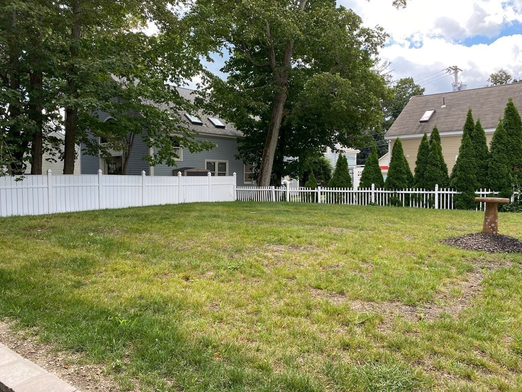 23 Main Street, Unit 2 Topsfield, MA 01983 - Photo 16 of 16 a view of a house with a yard