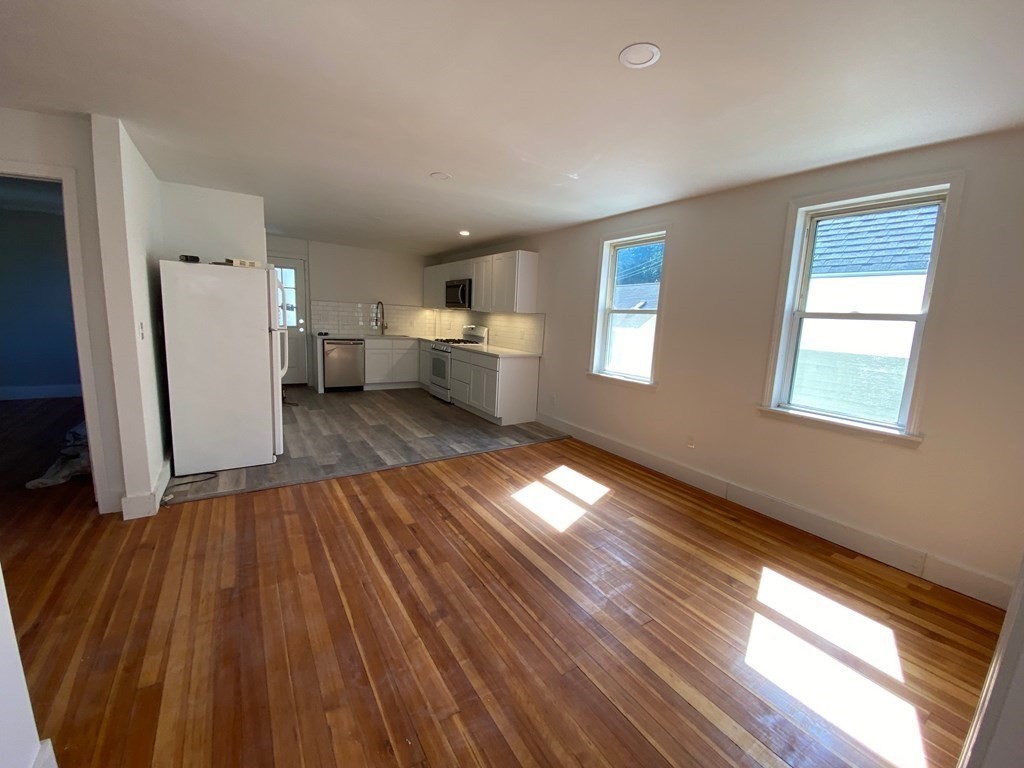 23 Main Street, Unit 2 Topsfield, MA 01983 - Photo 5 of 16 a view of a room with wooden floor and a window