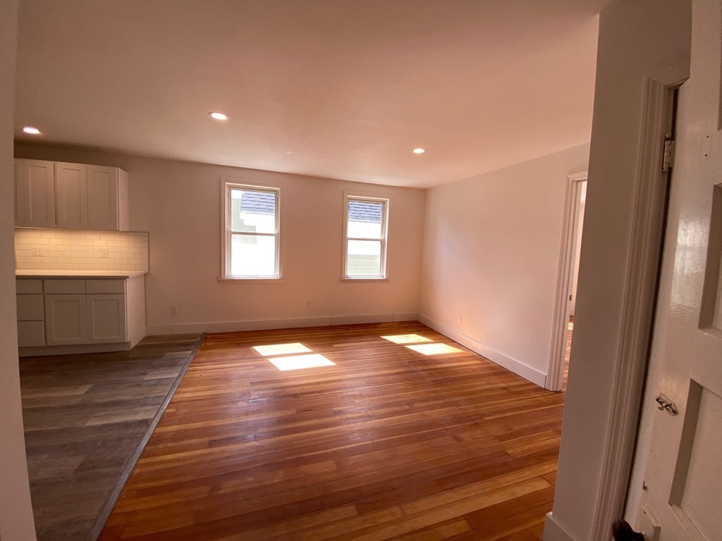23 Main Street, Unit 2 Topsfield, MA 01983 - Photo 6 of 16 a view of empty room with window and wooden floor