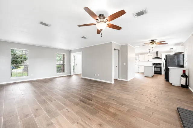 a view of a livingroom with hardwood floor and a ceiling fan