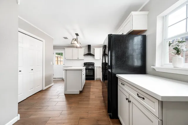 a kitchen with a refrigerator and a sink