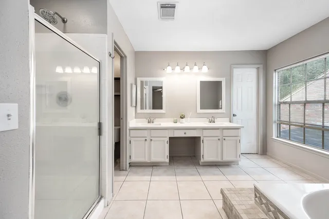 a large bathroom with a large mirror vanity and sink