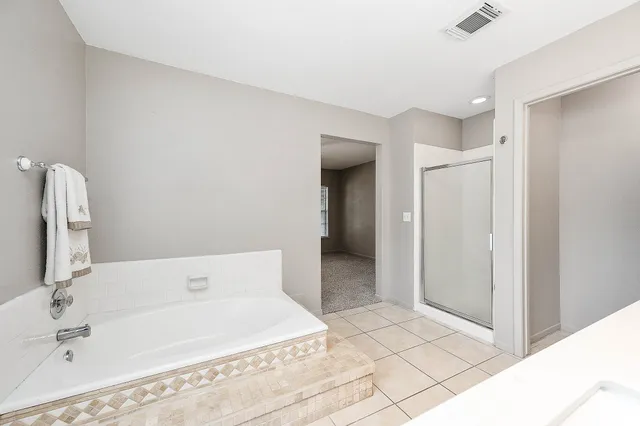 a bathroom with a tub sink and shower