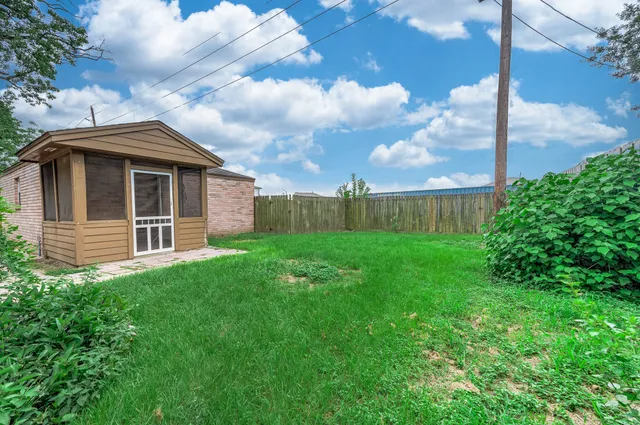 a view of an house with backyard space and garden