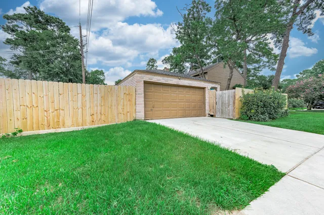 a front view of a house with a yard and trees
