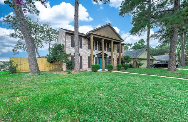 a front view of a house with a garden and plants
