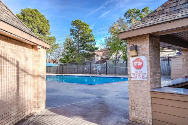 a view of a swimming pool with a yard