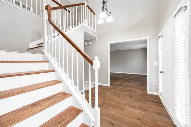 a view of entryway and hall with wooden floor