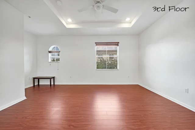 a spacious bathroom with a granite countertop sink a toilet and a mirror