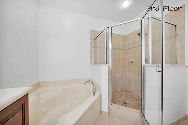 a bedroom with a bed and a ceiling fan