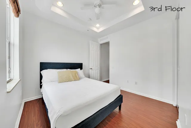 an aerial view of a house with a garden and lake view